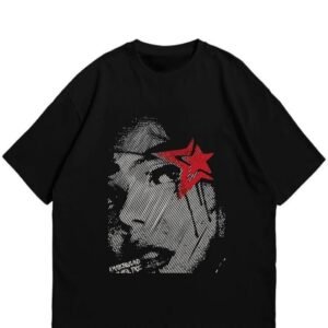 A black oversized t-shirt featuring a large grayscale graphic of a face in a halftone dot style with a single red star over the eye.