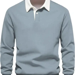 Front view of a men's sky blue long-sleeve rugby-style polo shirt featuring a crisp white contrast collar, a single-button placket, and ribbed cuffs.