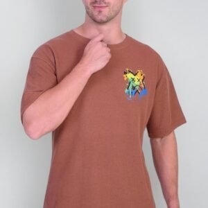 A man wearing a terracotta-colored oversized t-shirt with a small colorful graphic on the chest.