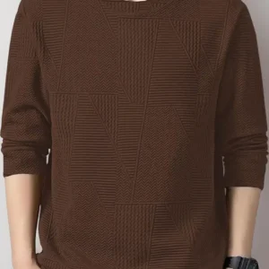 Man wearing a brown textured long-sleeve sweater with grey pants and a wristwatch.